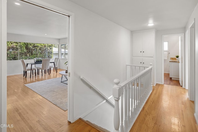 corridor with light hardwood / wood-style floors