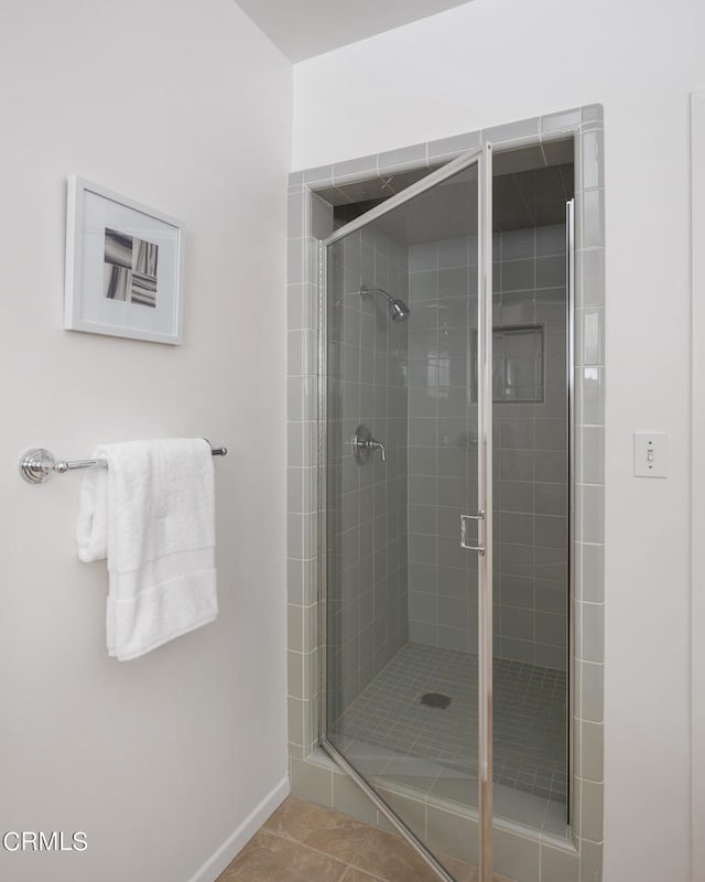 bathroom featuring tile patterned flooring and a shower with door