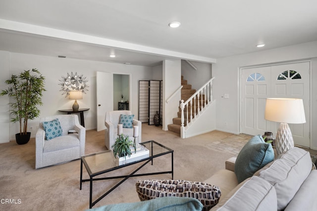 living room with beamed ceiling and light colored carpet