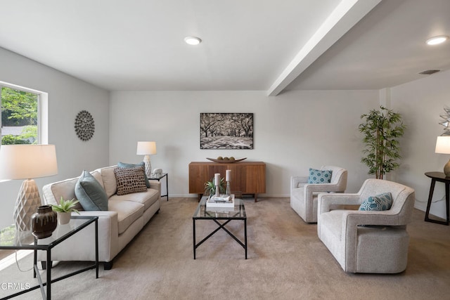 living room featuring beam ceiling and light carpet