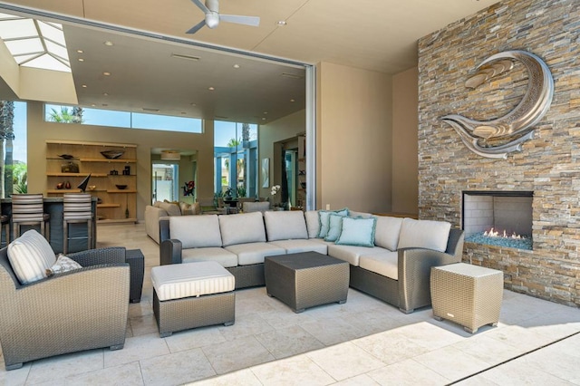 exterior space featuring ceiling fan and an outdoor living space with a fireplace