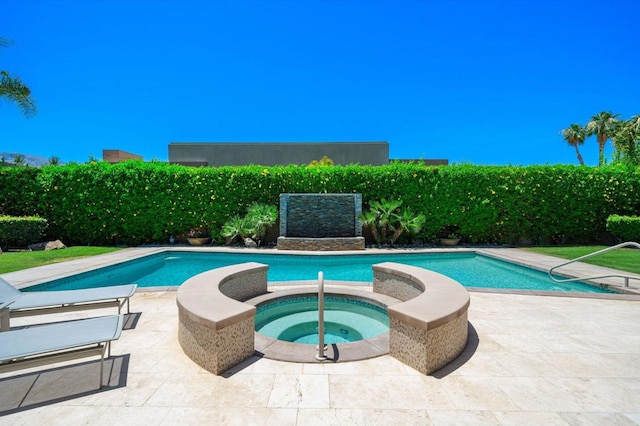 view of pool with an in ground hot tub and a patio