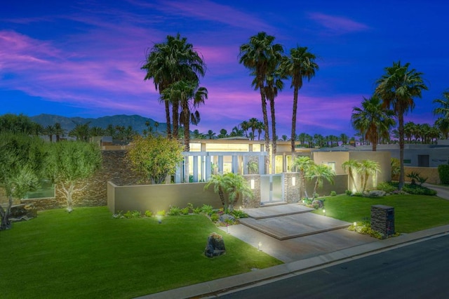 yard at dusk featuring a mountain view