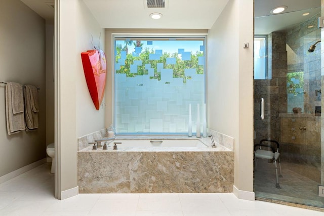 bathroom featuring toilet, shower with separate bathtub, and tile patterned floors