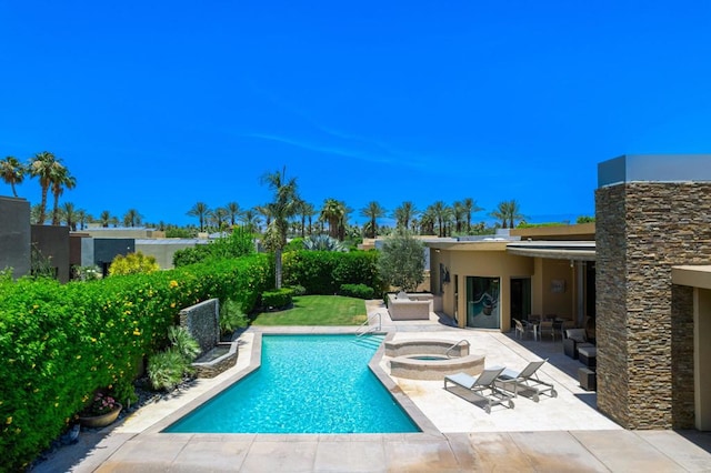 view of pool with an in ground hot tub and a patio area