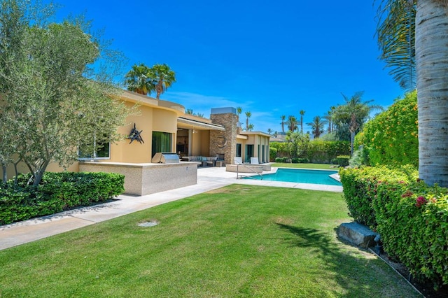 rear view of property with a yard and a patio