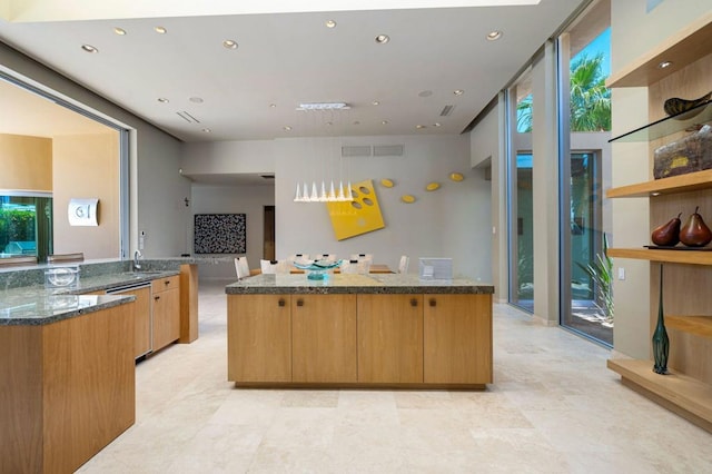 kitchen with kitchen peninsula, expansive windows, dishwasher, dark stone countertops, and a center island