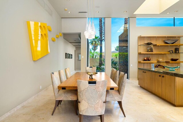 dining area featuring a wall of windows