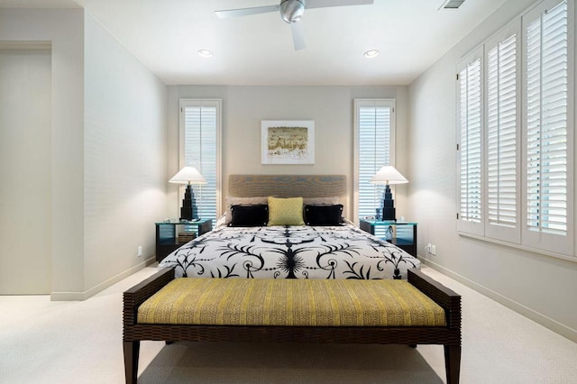 carpeted bedroom featuring ceiling fan and multiple windows