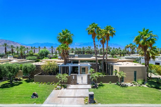 view of front facade with a front yard and a mountain view