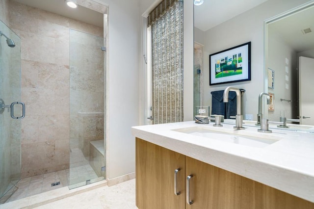 bathroom featuring vanity and a shower with door