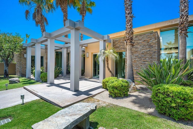 back of house featuring a patio and a yard