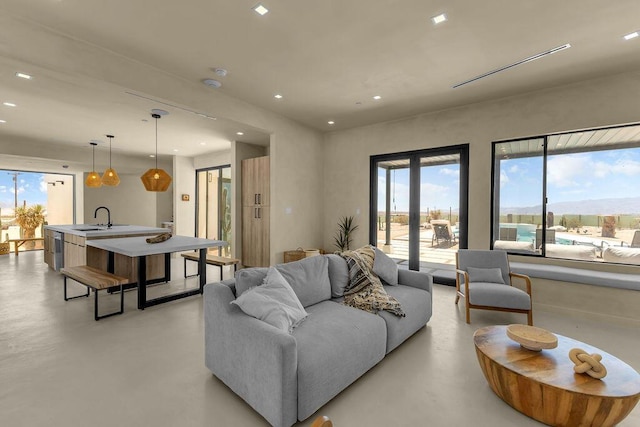 living room featuring sink and a water and mountain view