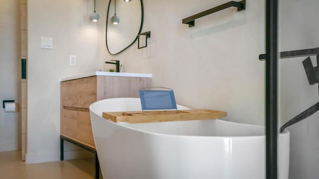 bathroom with vanity and a bath