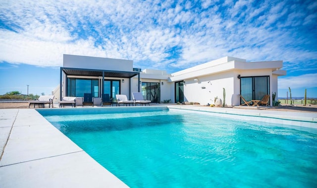 view of swimming pool with a patio area and an outdoor structure