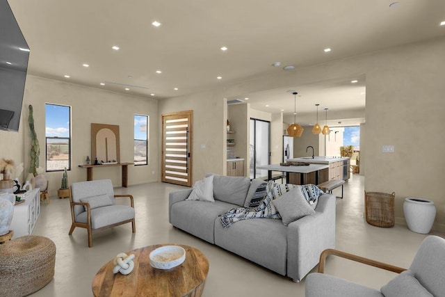 living room featuring plenty of natural light and sink