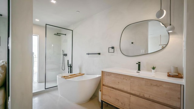 bathroom featuring vanity, concrete flooring, and independent shower and bath