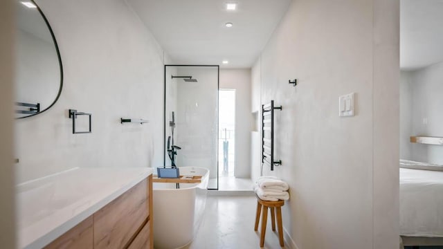 bathroom with vanity, concrete floors, and independent shower and bath