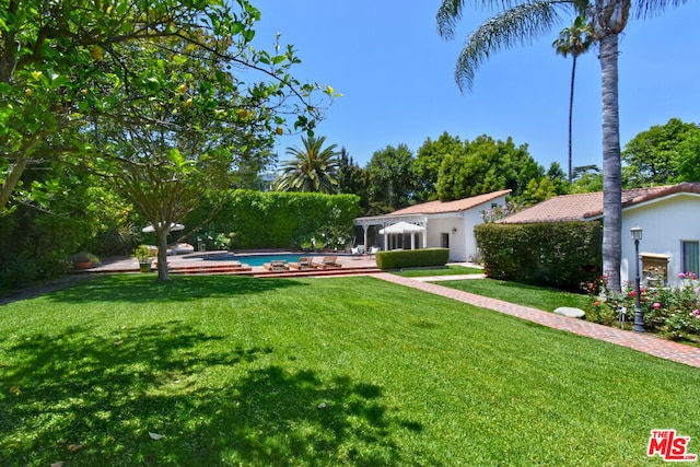 view of yard with a fenced in pool