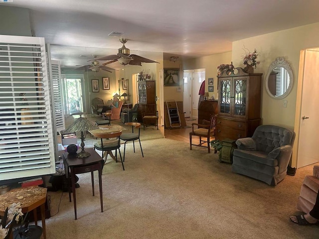 carpeted living room featuring ceiling fan