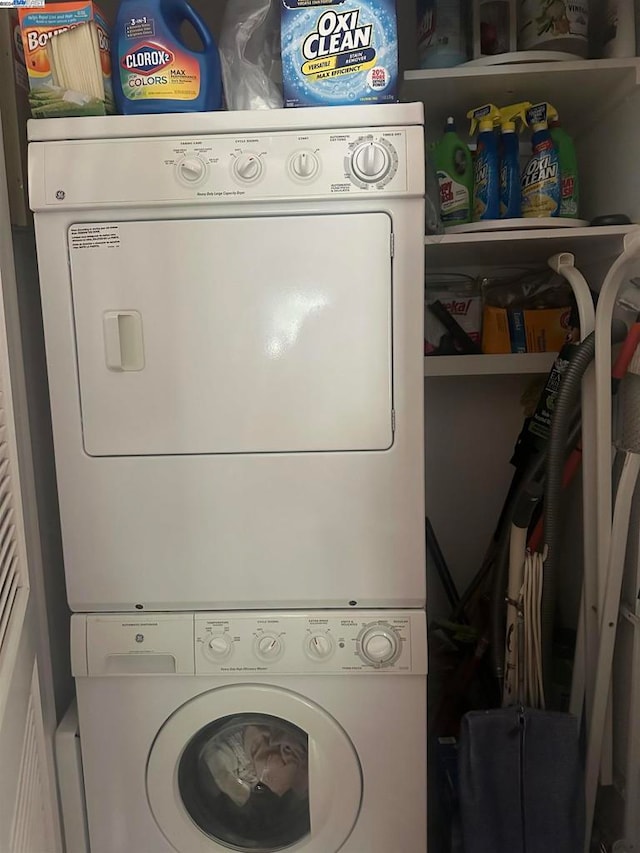 washroom featuring stacked washer and dryer