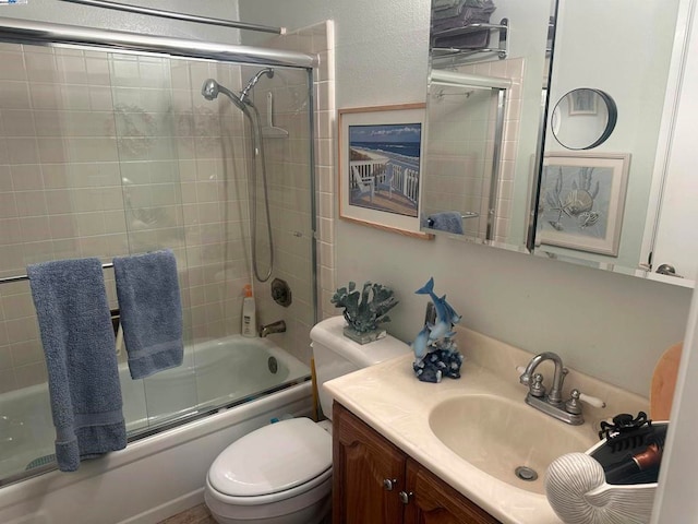 full bathroom featuring vanity, toilet, and bath / shower combo with glass door