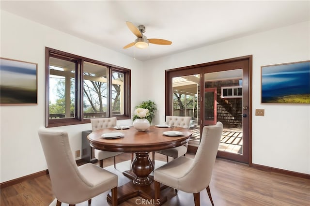 dining room with ceiling fan and hardwood / wood-style floors