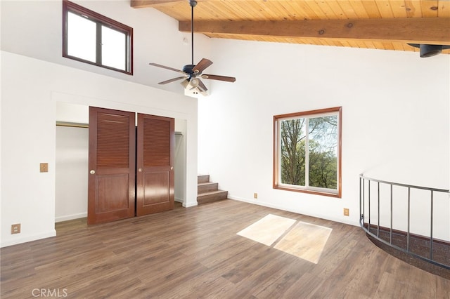 interior space featuring ceiling fan, wooden ceiling, dark hardwood / wood-style flooring, beamed ceiling, and high vaulted ceiling