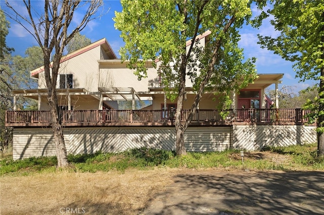 back of property with a wooden deck