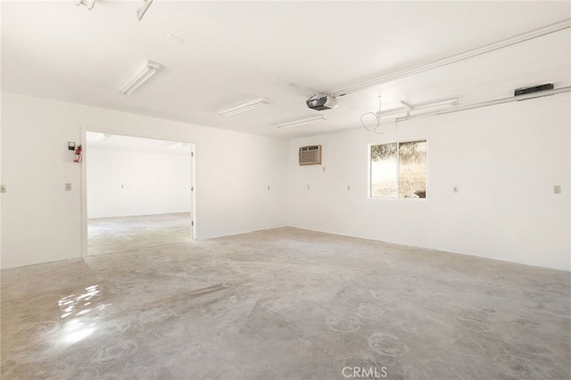 garage featuring a garage door opener and a wall mounted air conditioner