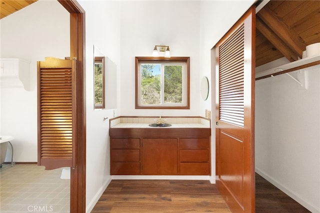 bathroom featuring vanity, lofted ceiling, and wood ceiling