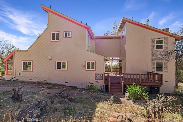 back of property featuring a wooden deck