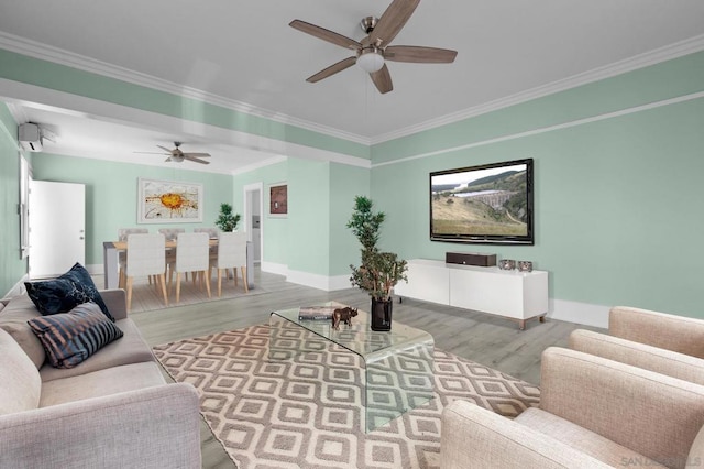 living room with hardwood / wood-style floors, ceiling fan, and ornamental molding