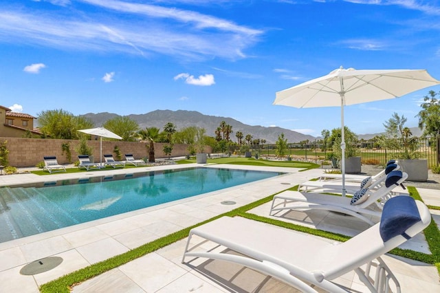 view of pool featuring a mountain view and a patio