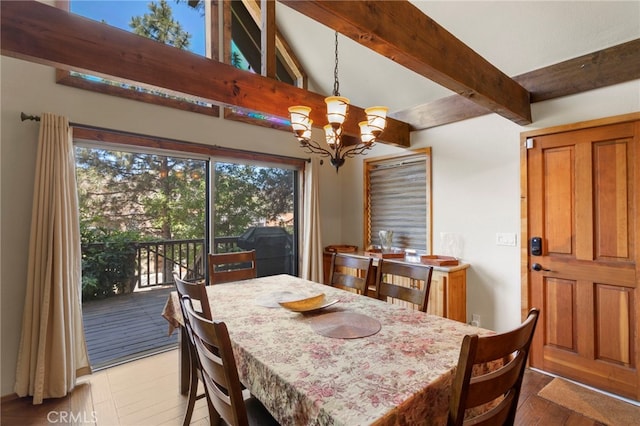 dining area featuring lofted ceiling with beams, light hardwood / wood-style flooring, and a notable chandelier