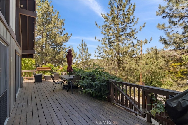 wooden deck with a grill