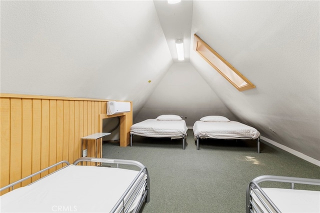 carpeted bedroom with vaulted ceiling with skylight