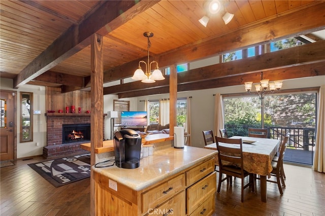 kitchen with dark hardwood / wood-style flooring, decorative light fixtures, and an inviting chandelier