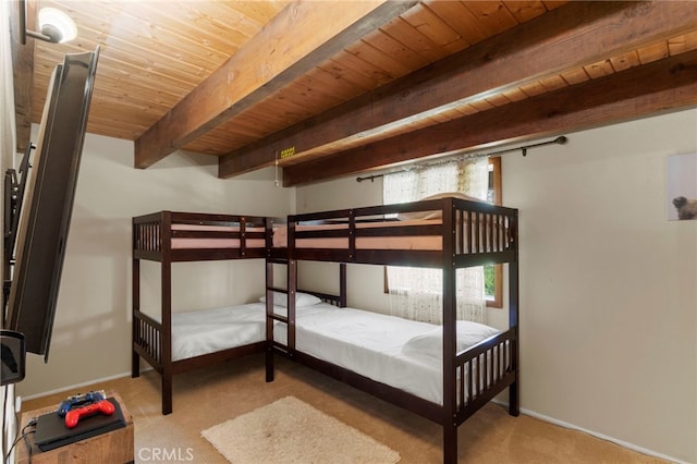 unfurnished bedroom with beamed ceiling, wooden ceiling, and light colored carpet