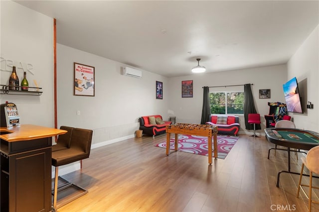 living room with light hardwood / wood-style floors and a wall mounted AC