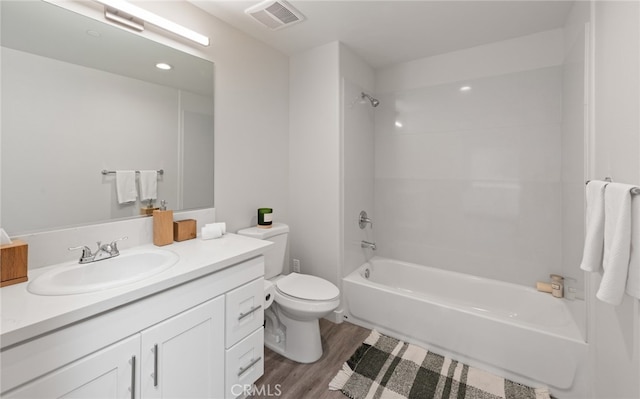 full bathroom featuring hardwood / wood-style floors, vanity, toilet, and shower / bathtub combination