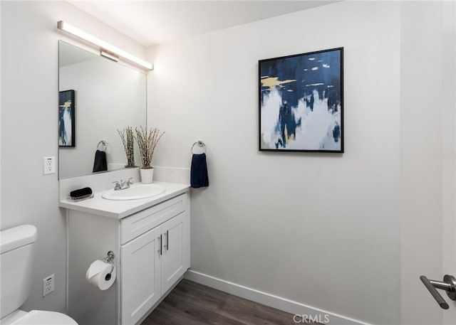 bathroom featuring vanity, toilet, and wood-type flooring