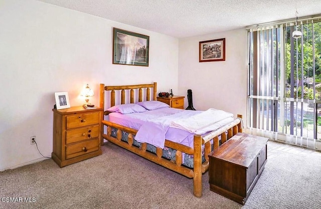 carpeted bedroom featuring a textured ceiling