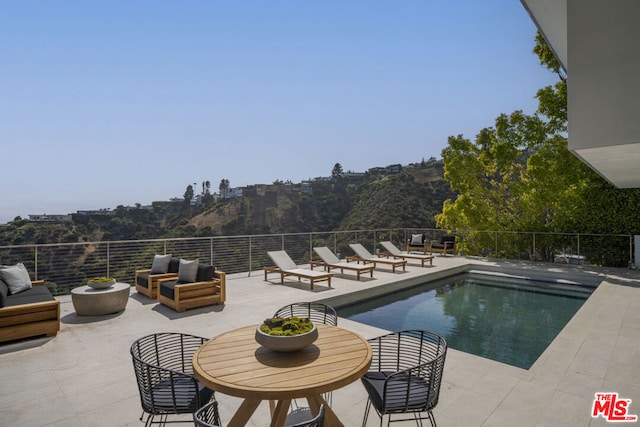 view of pool featuring a patio and an outdoor hangout area