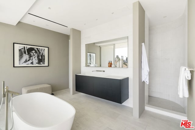 bathroom featuring tile patterned flooring, vanity, and a bathtub