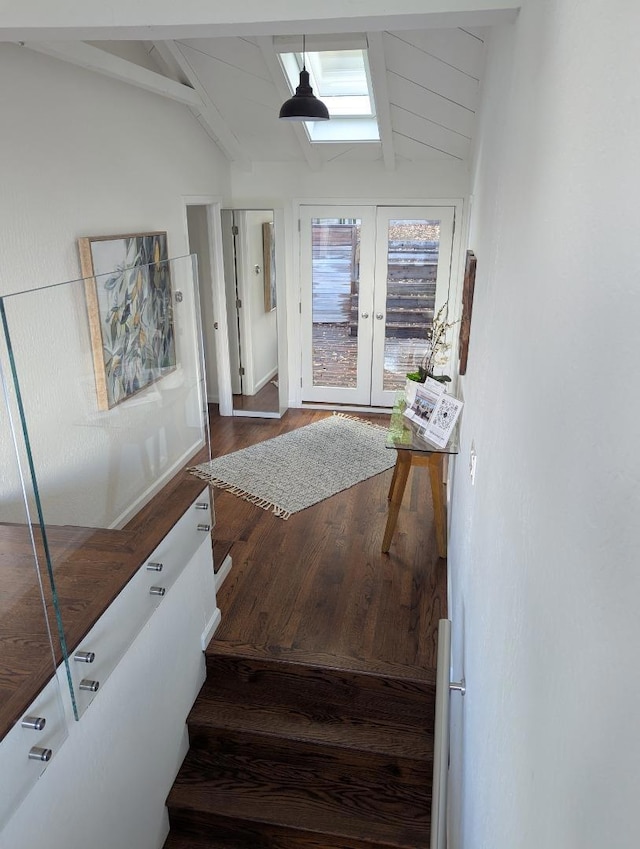 interior space with vaulted ceiling with beams, french doors, and hardwood / wood-style flooring