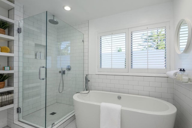 bathroom with separate shower and tub