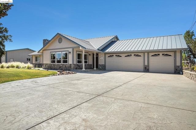 ranch-style home with a garage and a front lawn