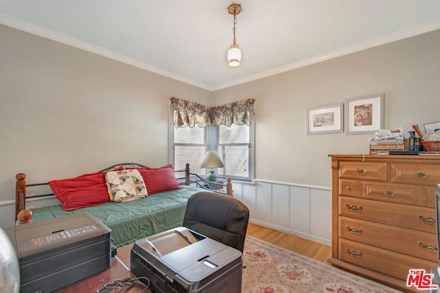 bedroom featuring light wood-type flooring and crown molding