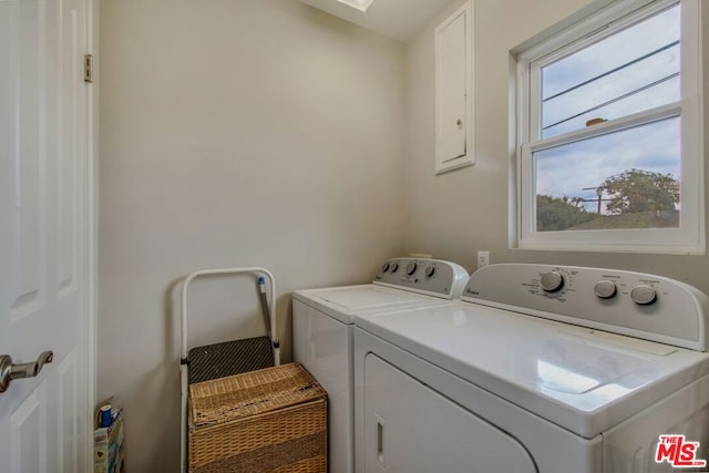 clothes washing area featuring separate washer and dryer